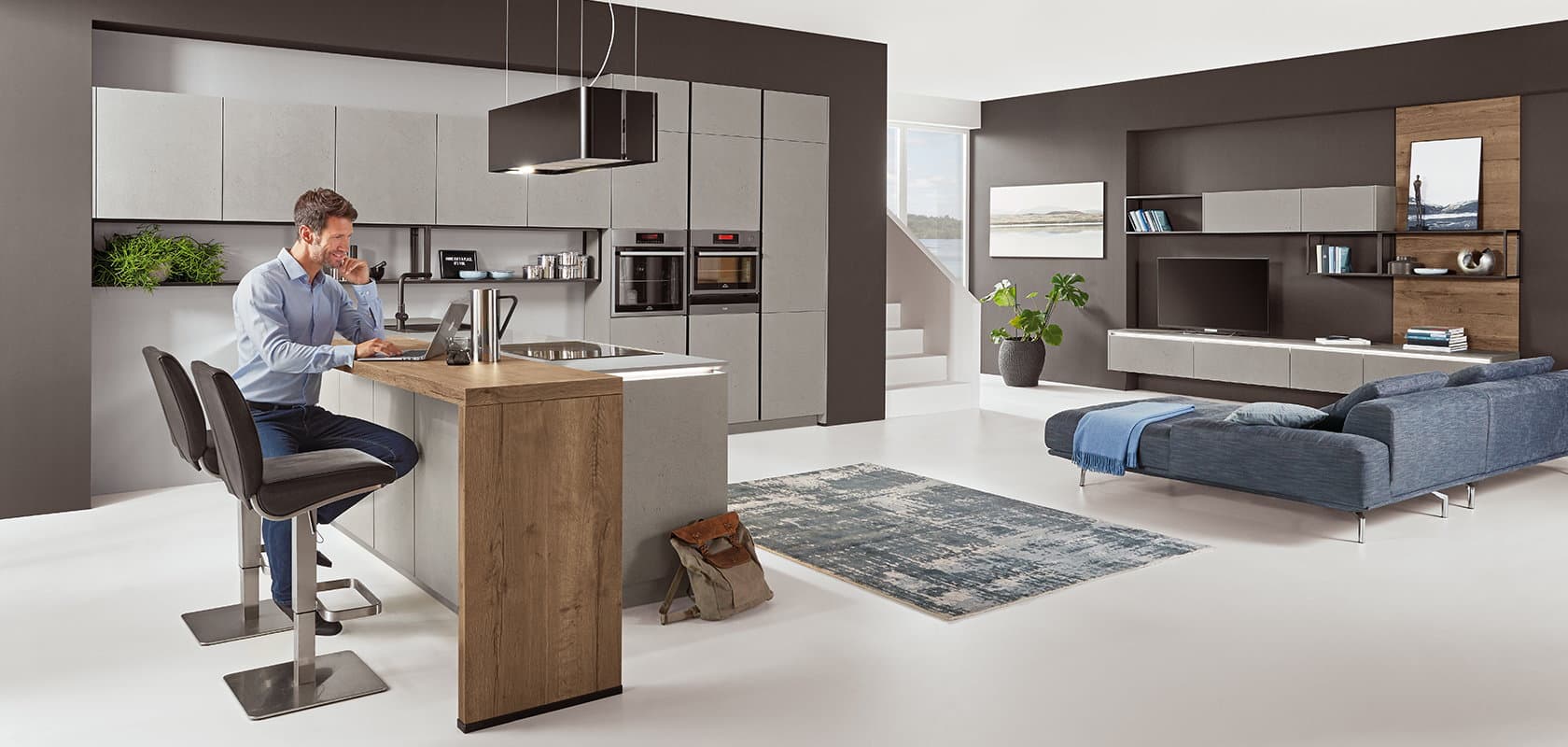 Thuiswerken aan het schiereiland met bar – Grijze design keuken Nobilia Cemento